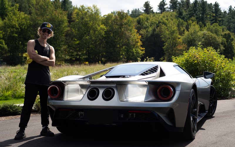 Jake Ramos CEO and Head Detailer standing next to a happy customers Ford GT LM